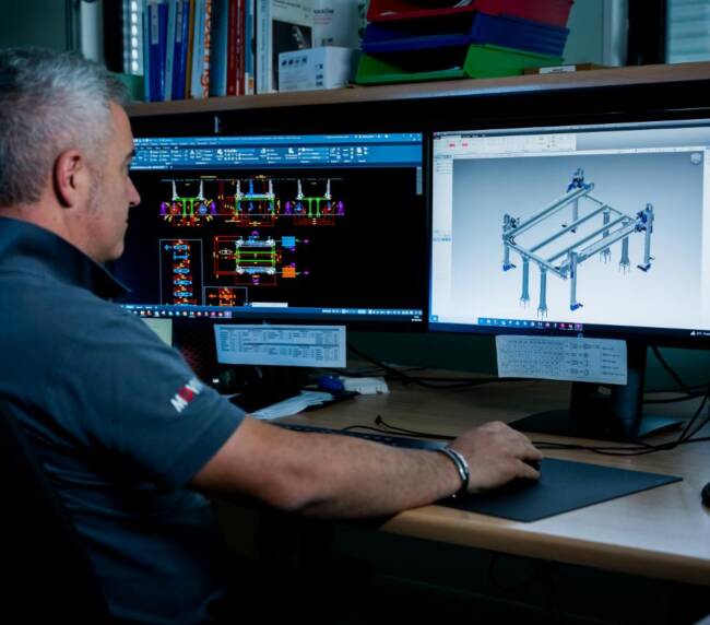Movin mechatronic engineer designing automated manipulators in 3D for a commercial display cabinet assembly line