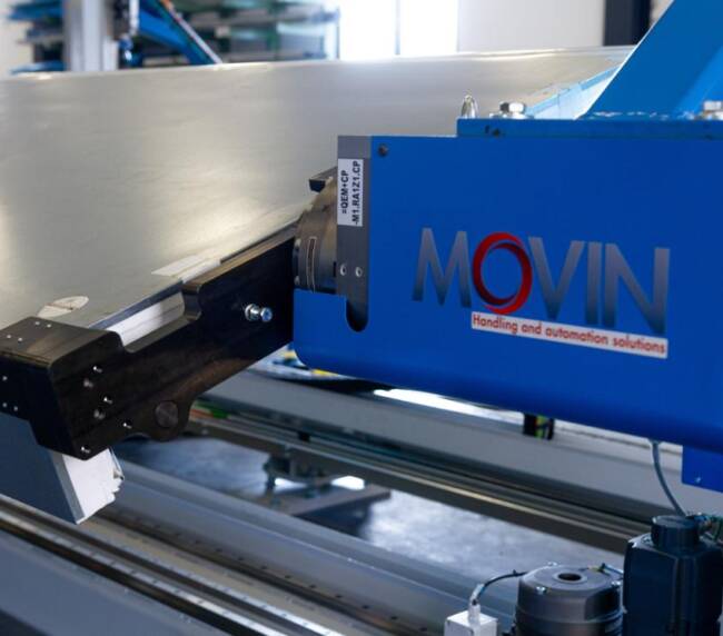 Manipulator designed and built by Movin, with automatic gripper handling a foam sandwich panel used to assemble commercial refrigeration cabinets