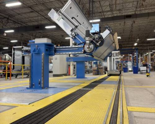 Assembly line for commercial refrigeration cabinets featuring assembly stations and automated machines for product tilting
