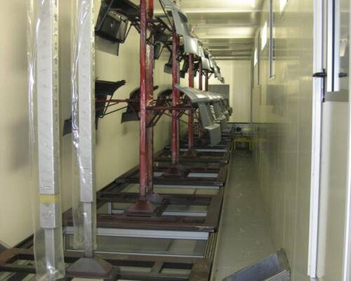 Automotive bumpers conveyed through a painting plant equipped with a Movin handling system